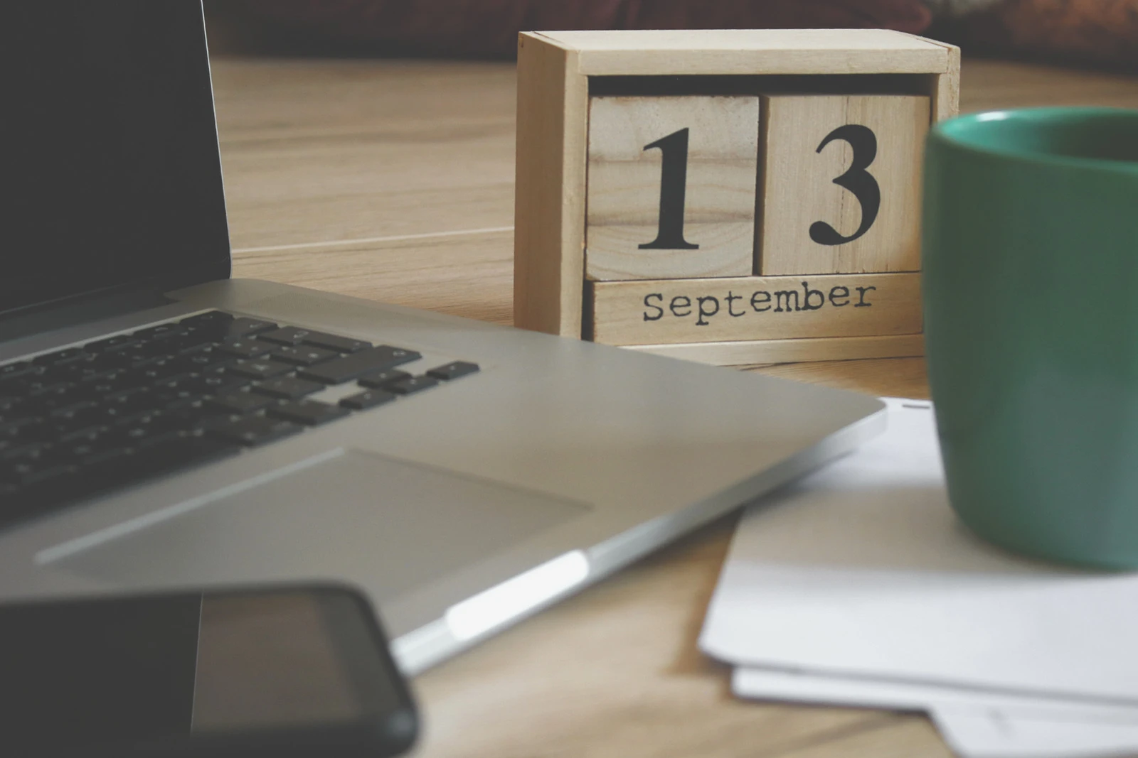 Canva - Brown Wooden Block Desk Calendar Displaying September 13